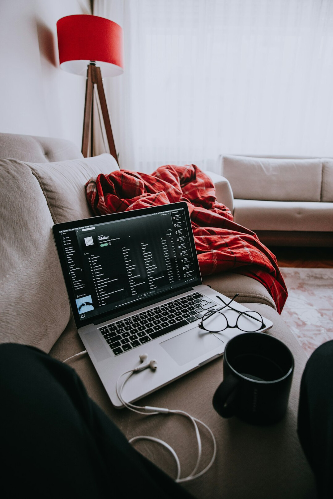 person coding on couch at home