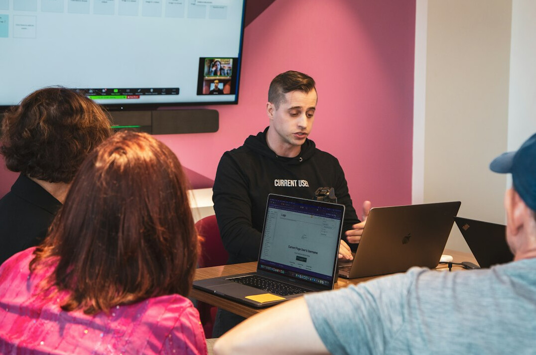 group of students discussing code